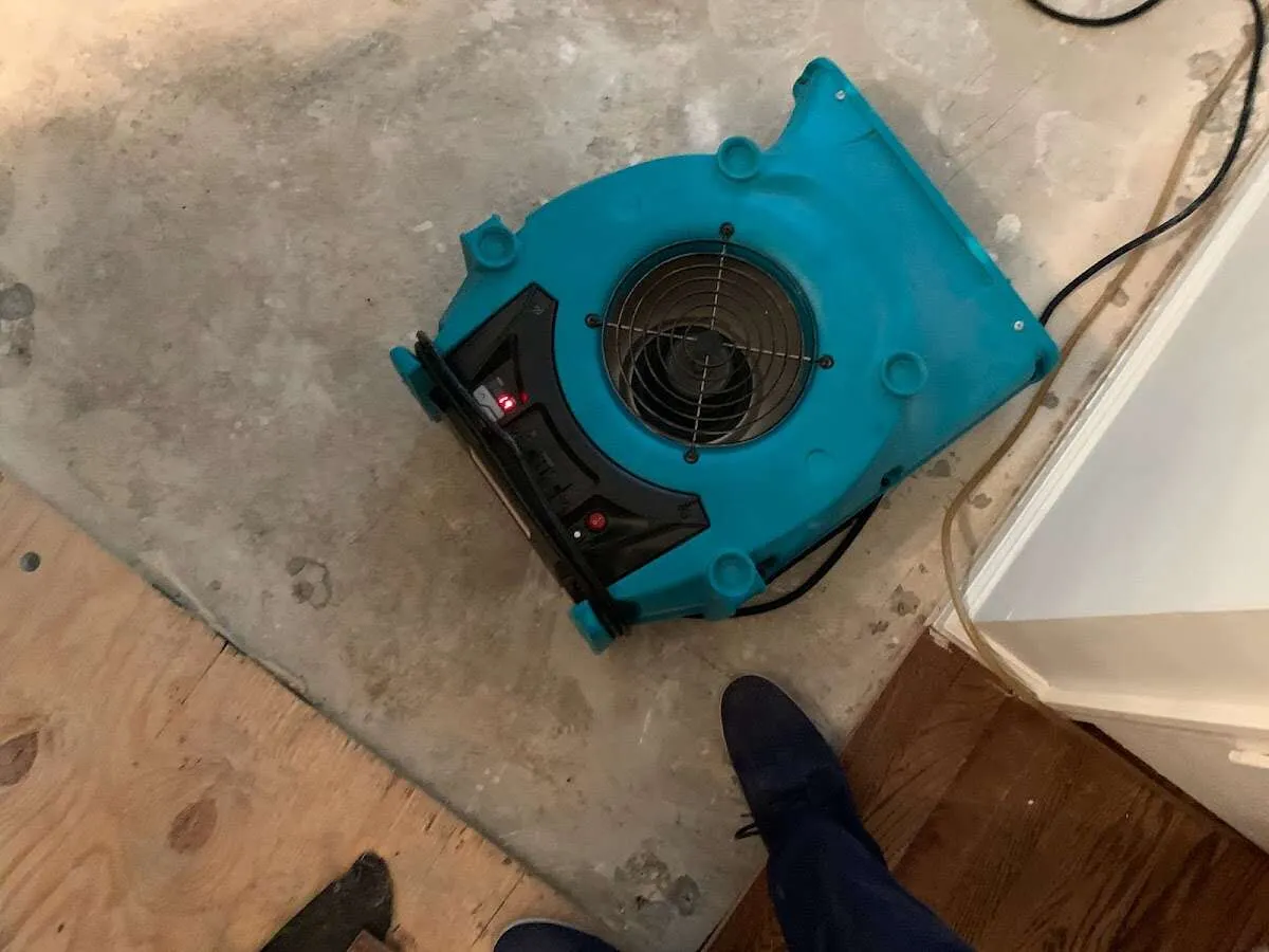 Air mover drying subfloor during Commercial Water Damage Restoration in Polk City